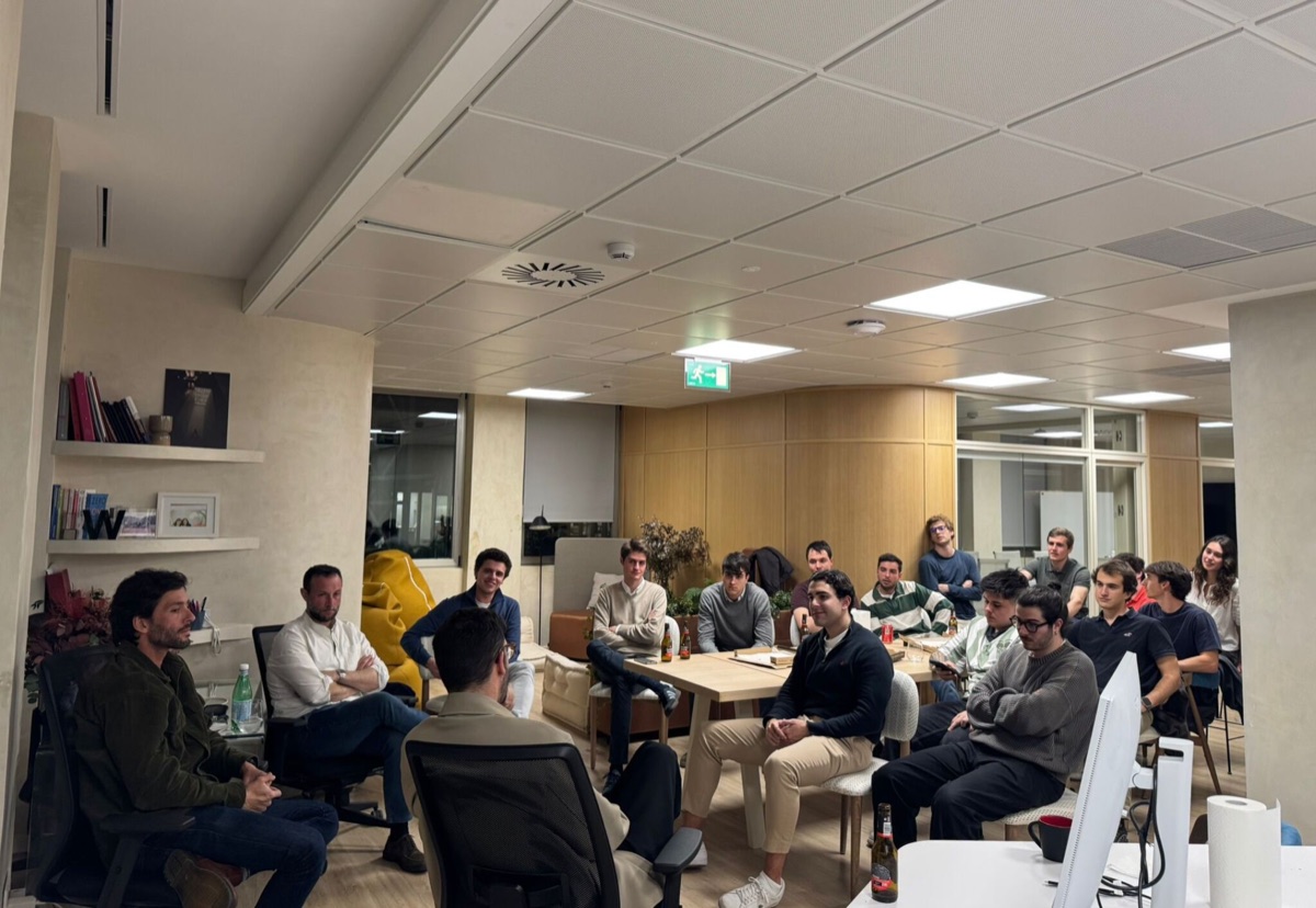 Fellows gathered for an evening session at an office